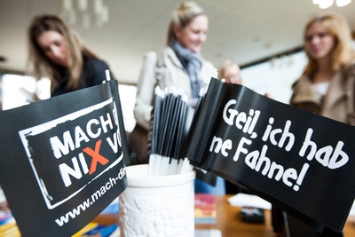Zwei Papierfähnchen mit aufgedrucktem Slogan